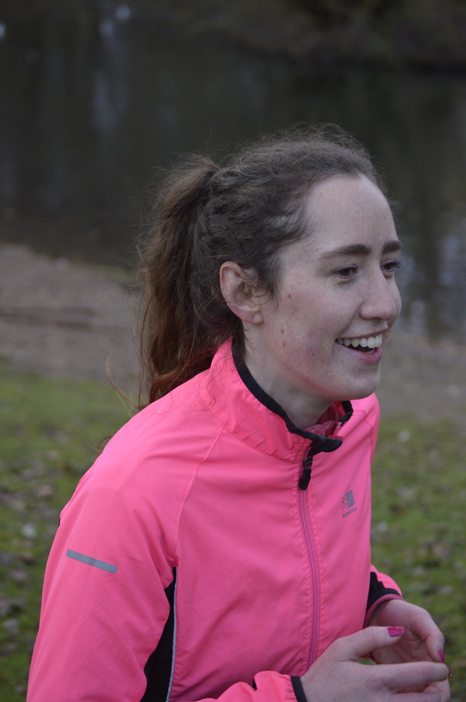 Katie running outdoors in a pink jacket